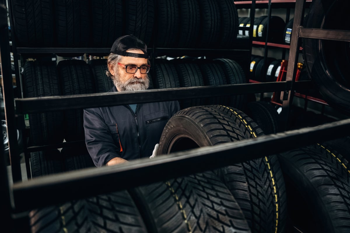 Professional tire technician at work in an automotive shop
